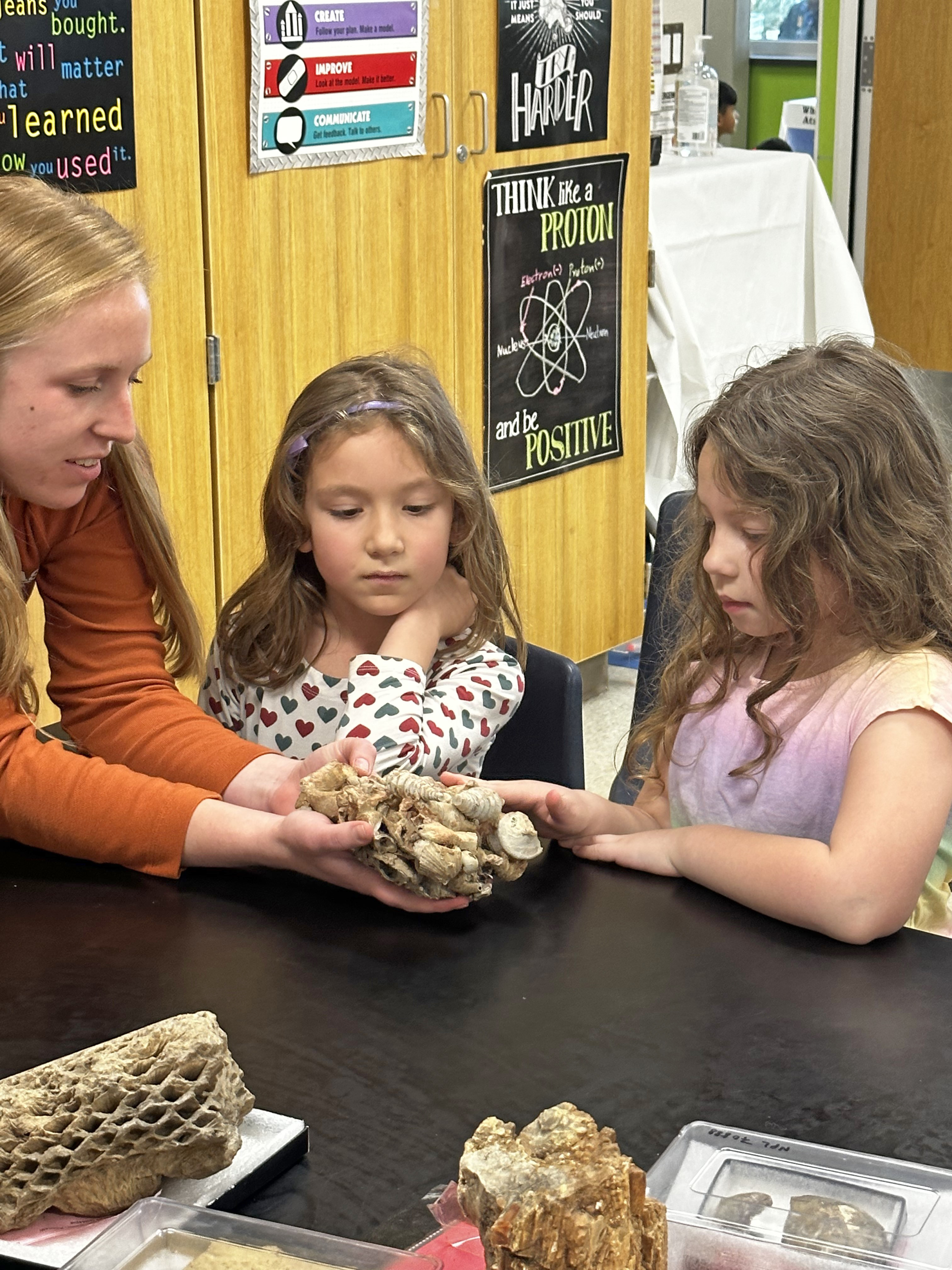 Lucy showing fossils to children
