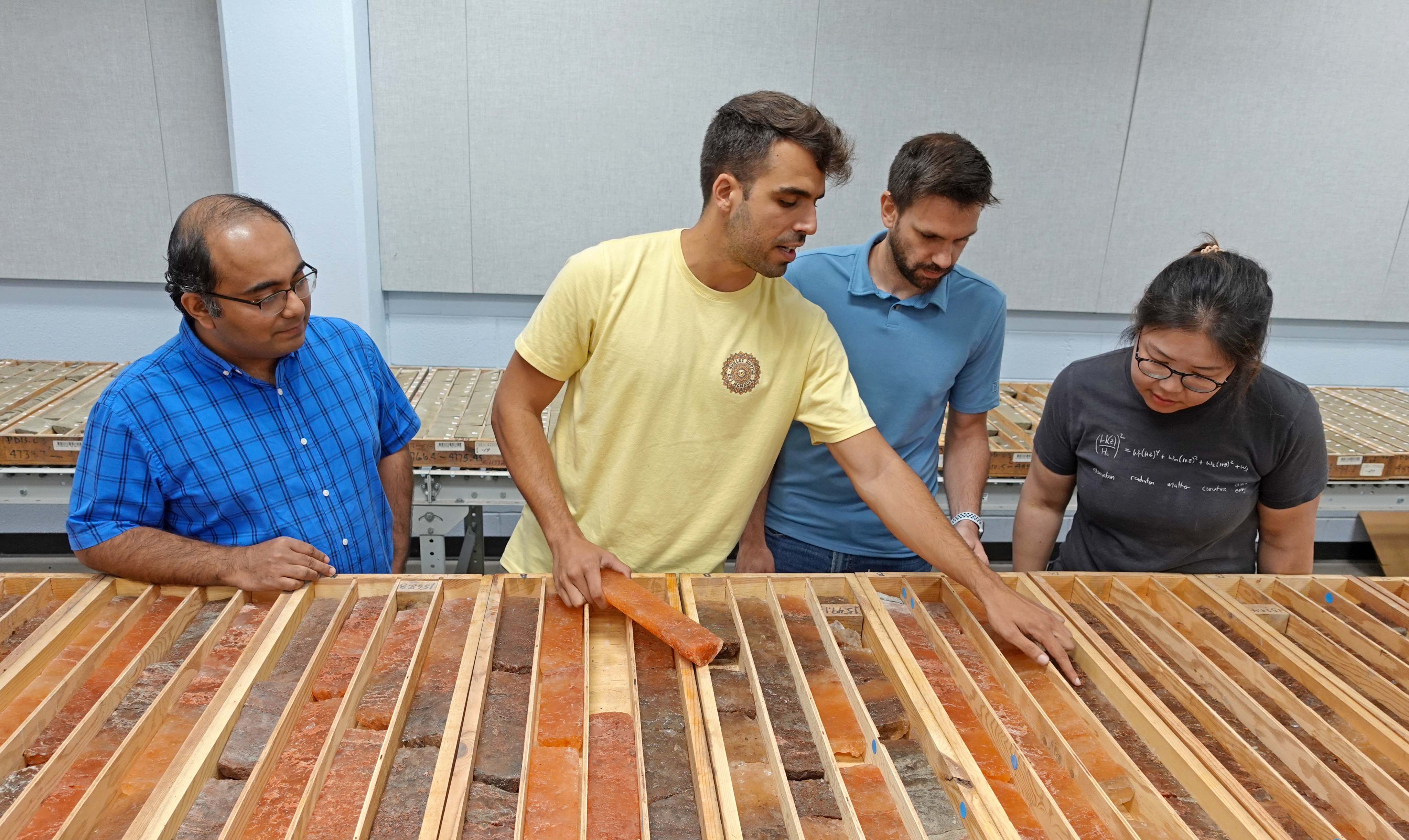 Researcher looking at core