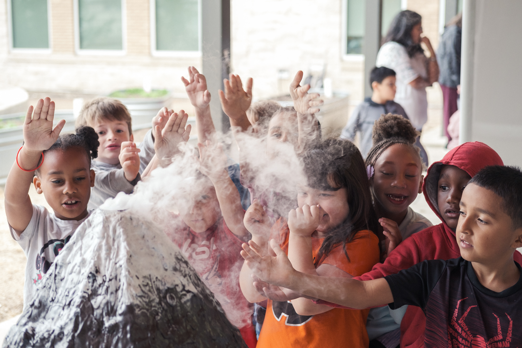 Children watching model volcano