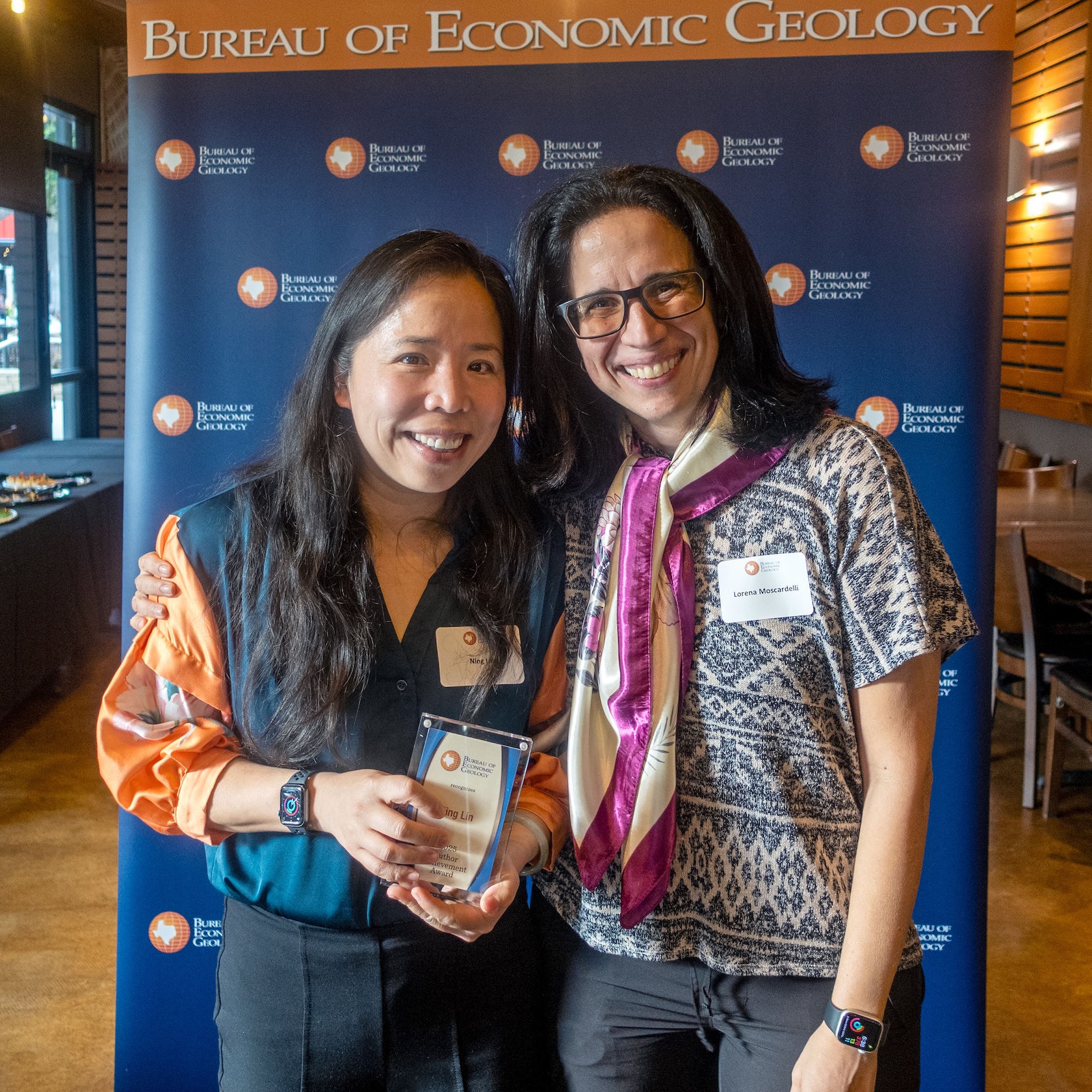 Ning Lin accepts the Bureau’s 2025 Author Achievement Award from Director Lorena Moscardelli