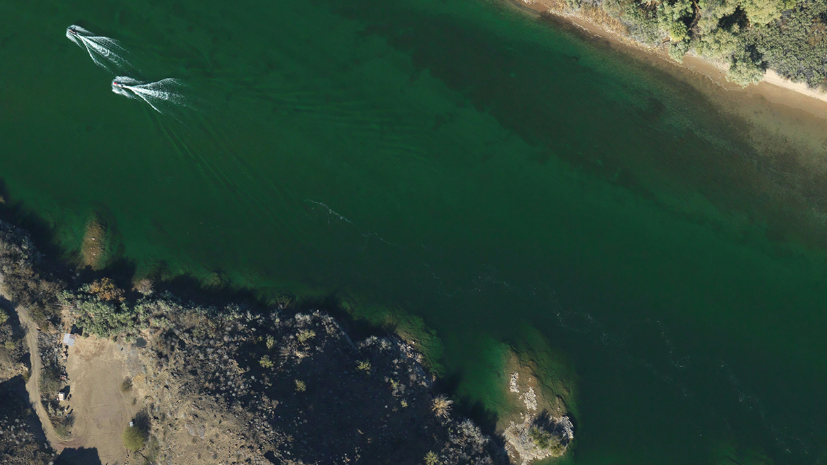 400 meters above the Colorado River, the Bureau's lidar survey plane photographs BEG survey craft acquiring bathymetric and turbidity data.