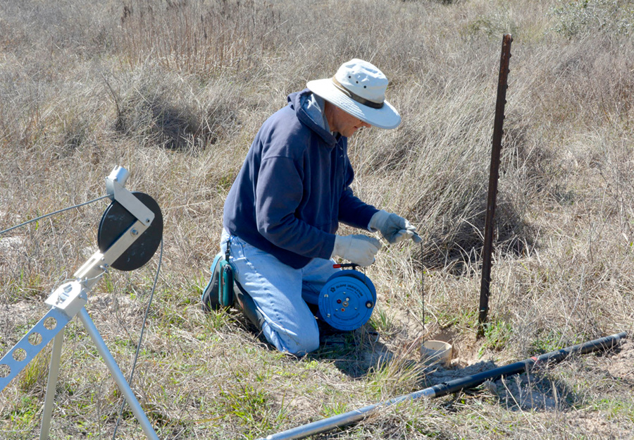 Measuring water depth in a water well before geophysical logging.