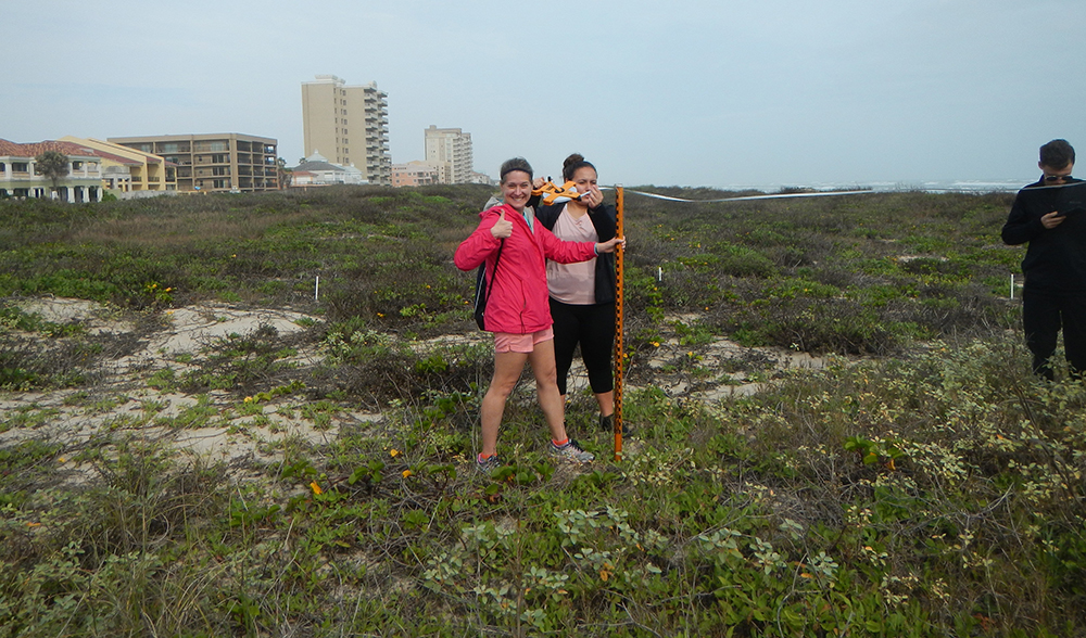 People taking measurements at beach