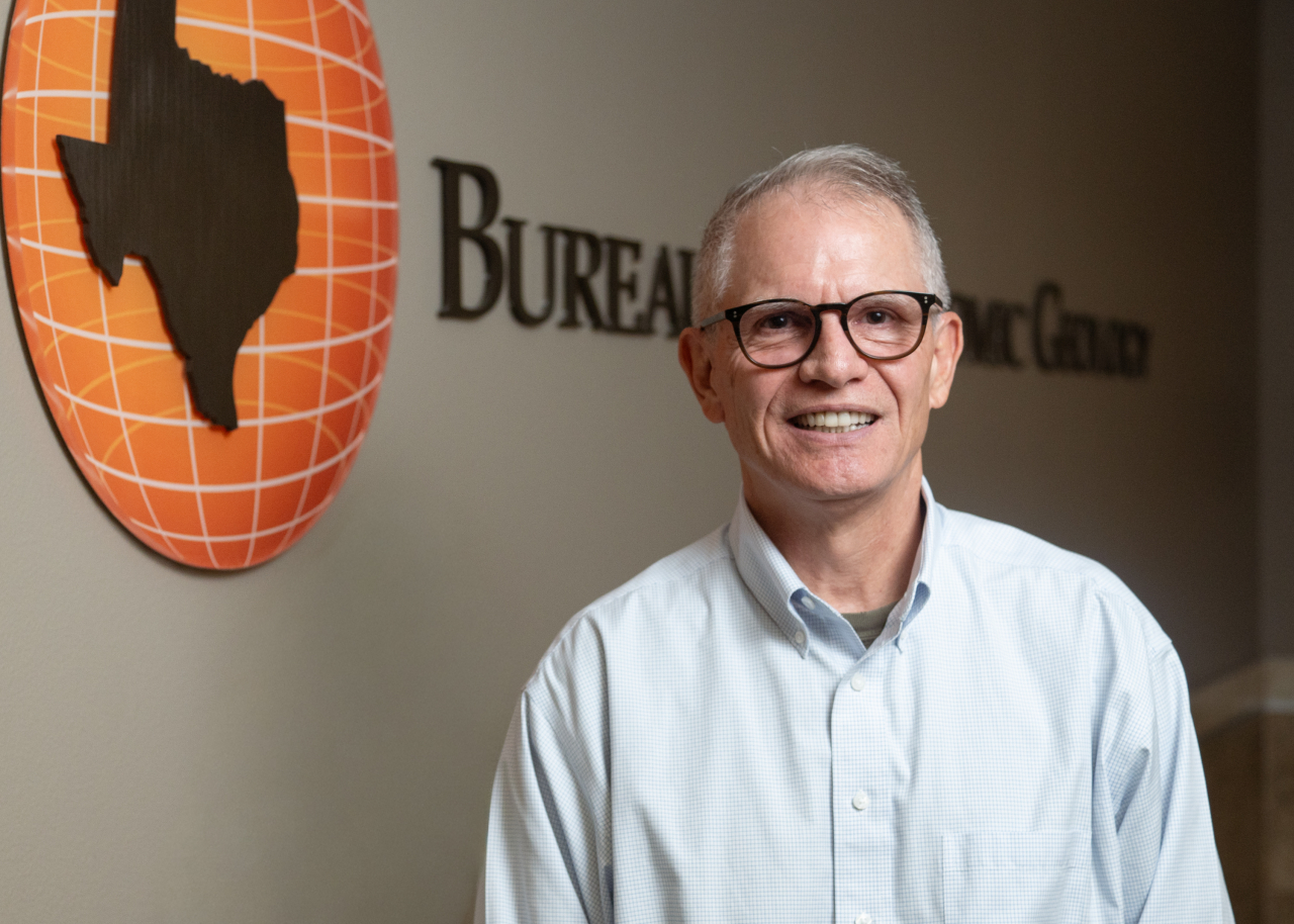 Professional quality photo of Mark Shuster with Bureau Logo in Background