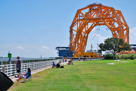 A floating crane and the 1857 lighthouse at Sabine Pass