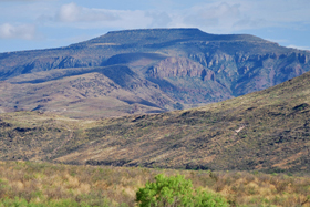 Star Mountain, tall rhyolite cliffs with an ash flow tuff capping the mesa at its top